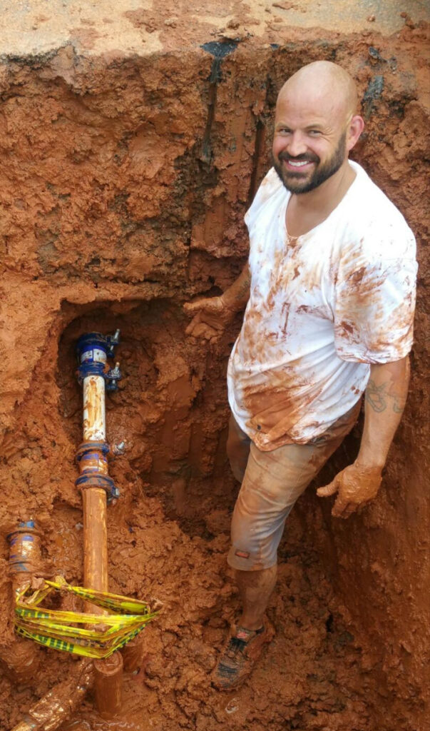 Rideout Plumbing technician investigating an underground pipe leak